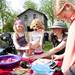 Stella Bird and Samantha Richardson interact with toys and gadgets on a table at the Cobblestone Farm Farmers Market on Tuesday, May 21. Daniel Brenner I AnnArbor.com